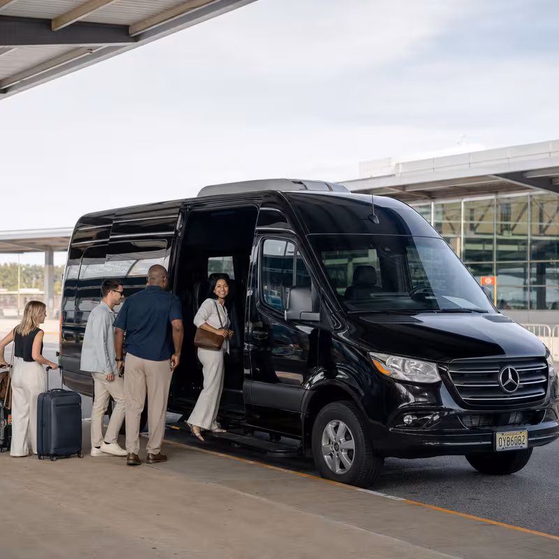 Group boarding a white charter bus for Airport Transportation transportation in New Brunswick