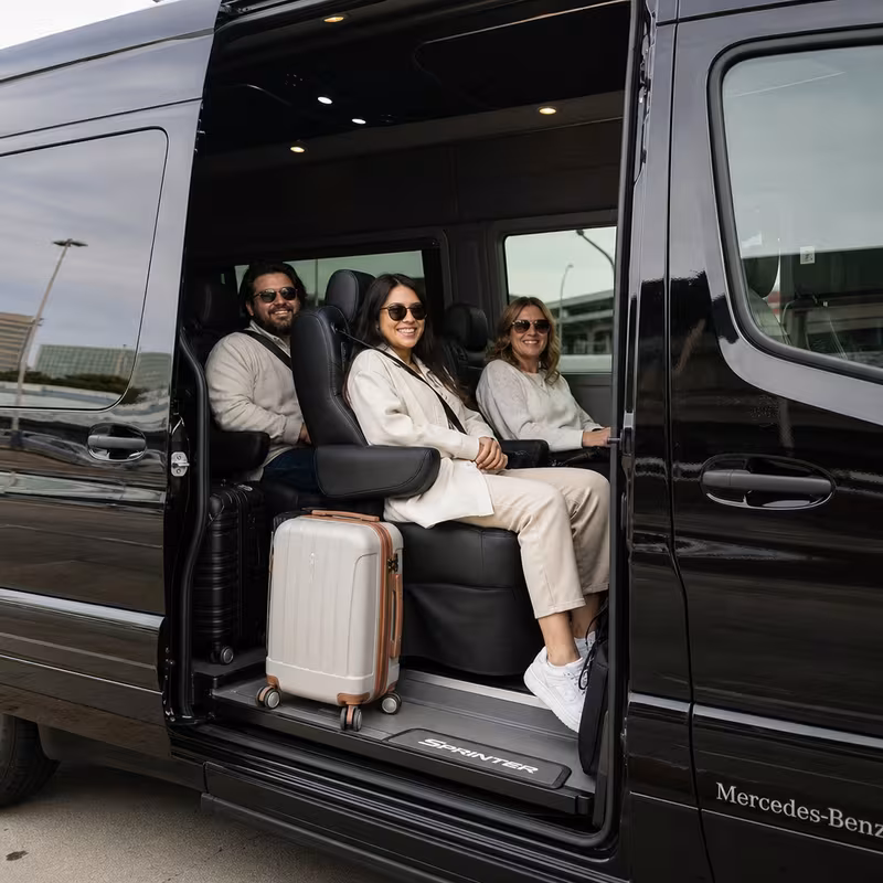 Passengers loading luggage while boarding an New Brunswick group shuttle