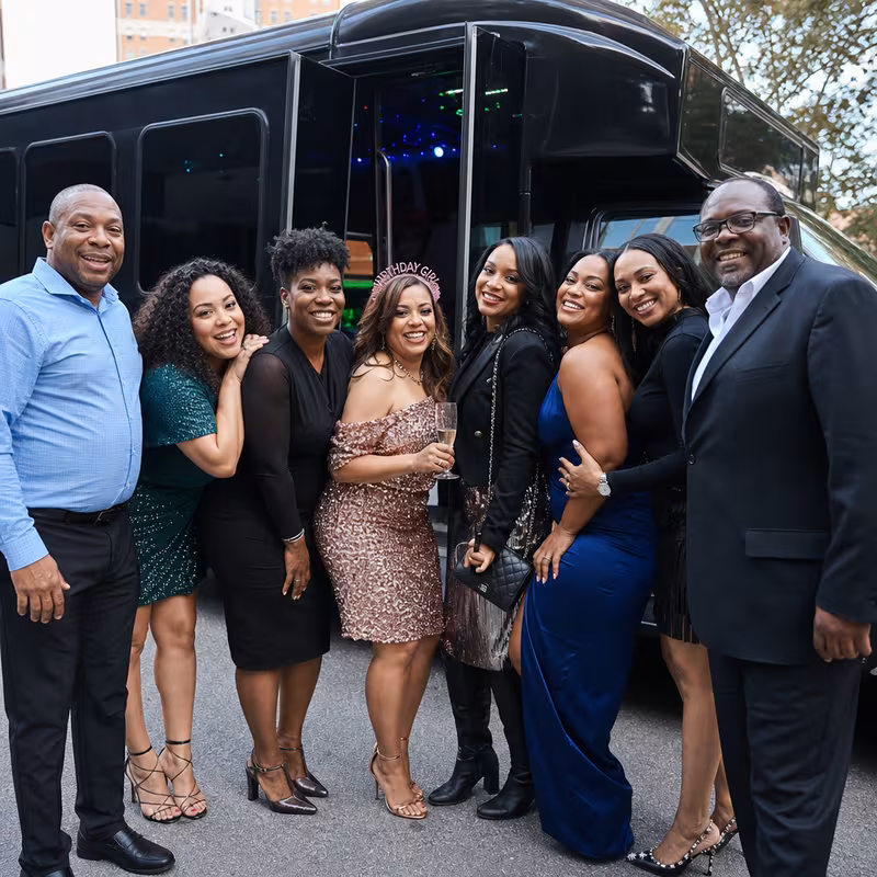 Group boarding a white charter bus for Birthday Transportation transportation in New Brunswick