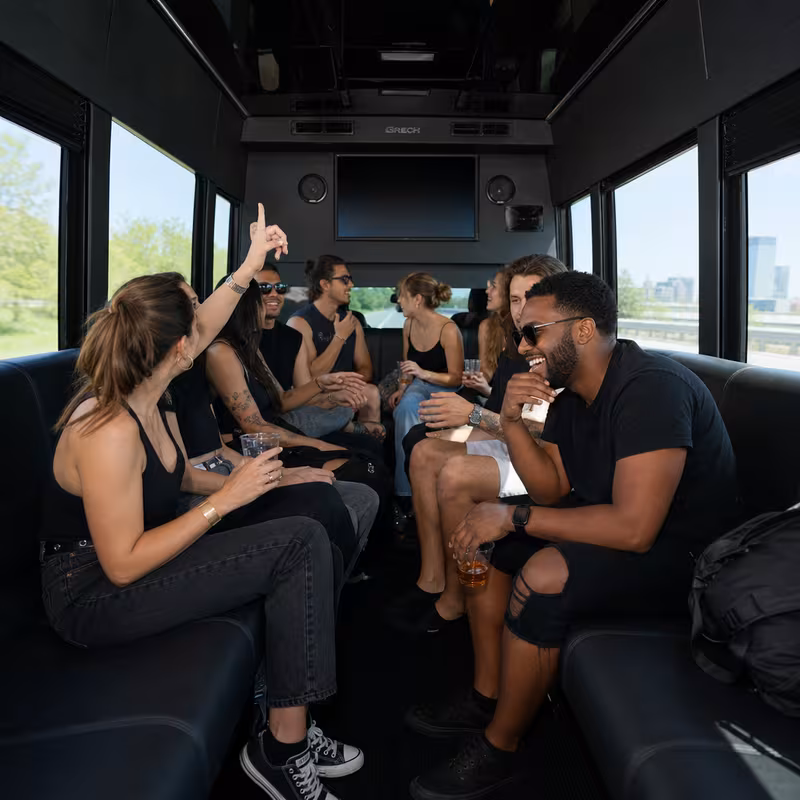 Group boarding a white charter bus for Concert Transportation transportation in New Brunswick