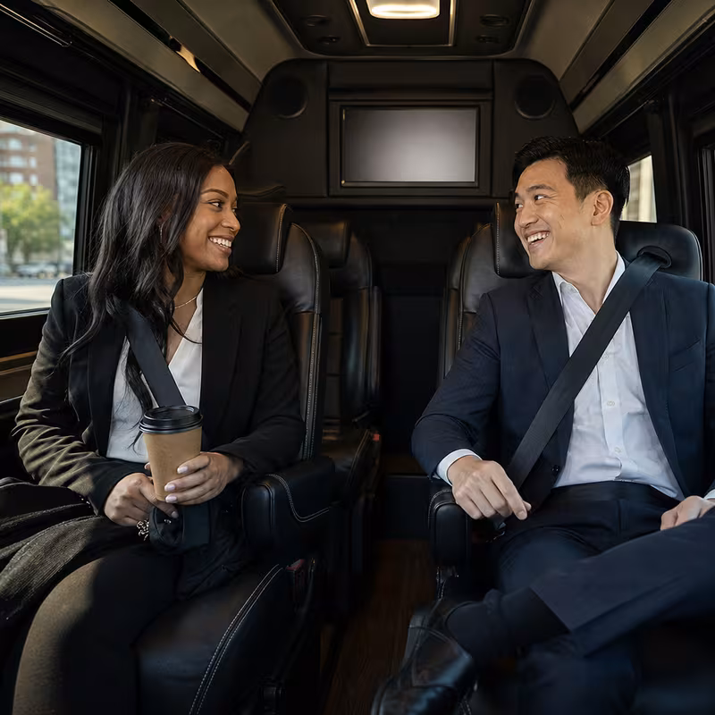 Group boarding a white charter bus for Corporate Transportation transportation in New Brunswick