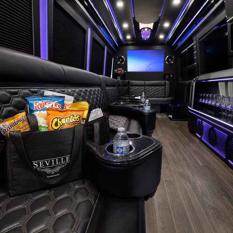 Party bus interior with wraparound leather seating and LED lighting in New Brunswick